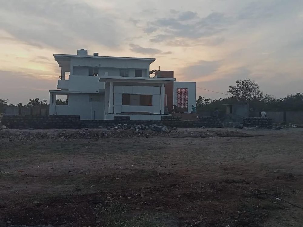 Modern flat-roof residential villa at dusk during finishing stage